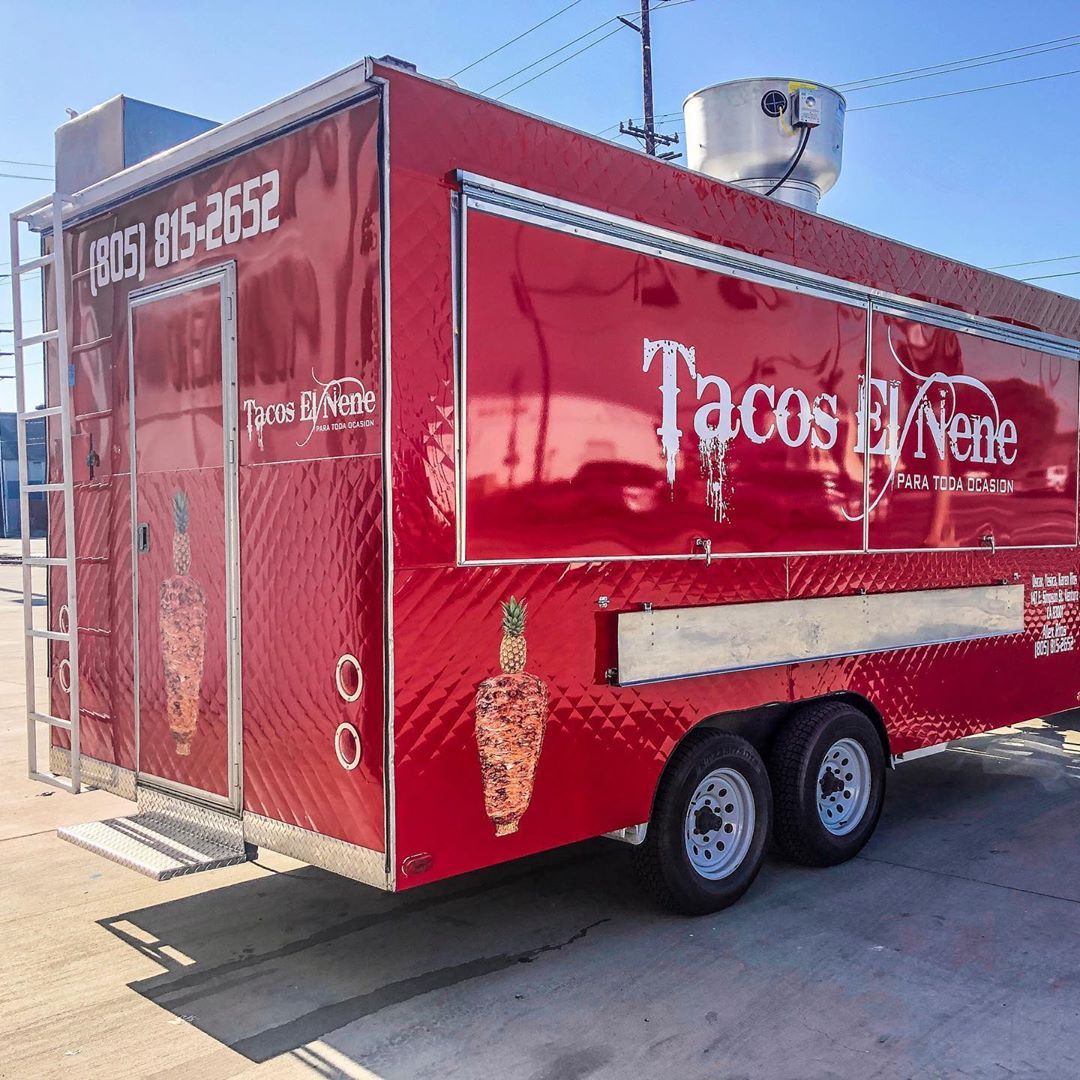 A red tacos el norte food truck is parked in a parking lot