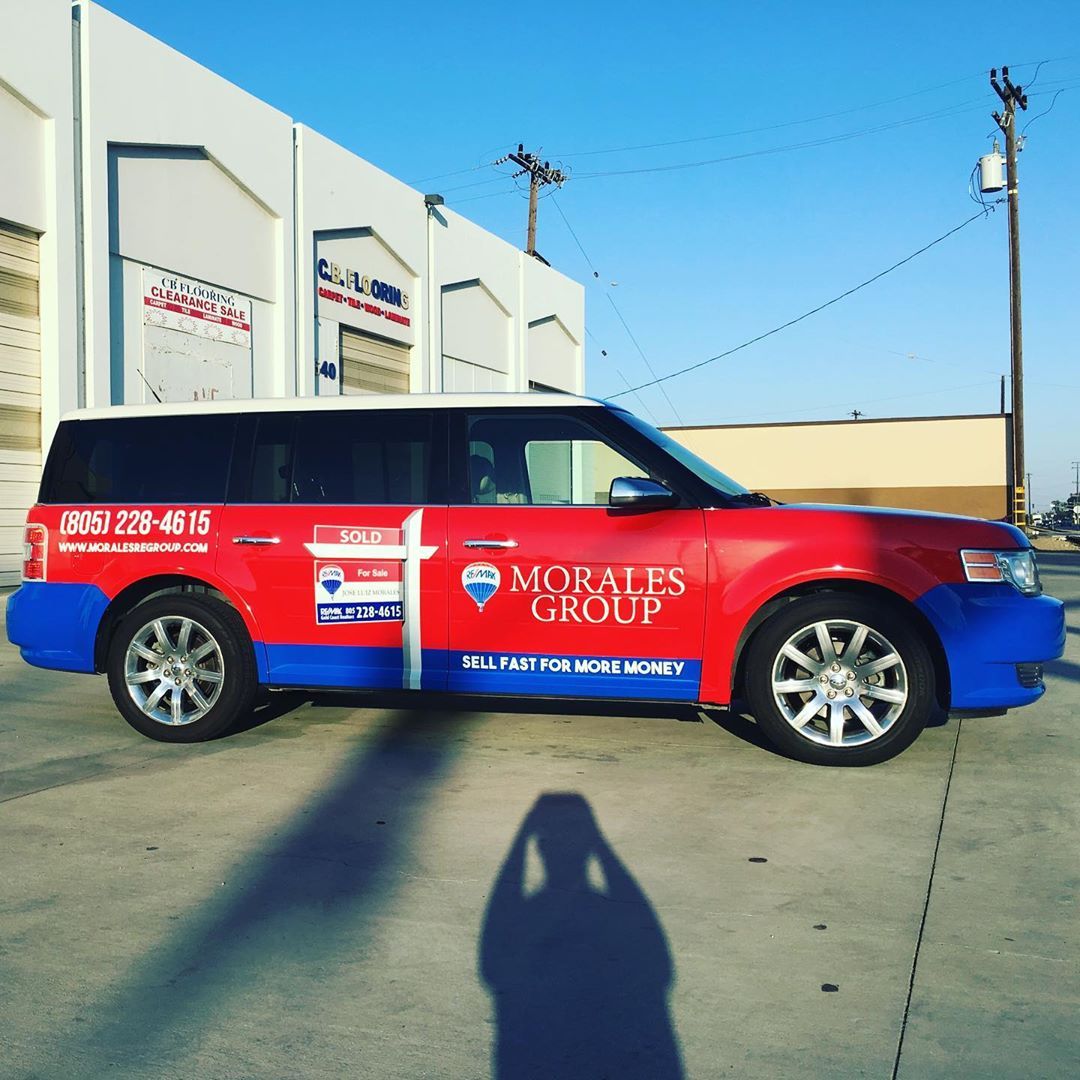 A red and blue car with morales group written on the side