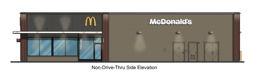 A McDonald's restaurant with a modern design, tan exterior, and glass front entrance, no drive-thru.