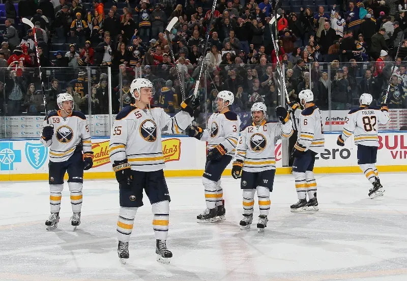 A group of hockey players are standing on the ice.