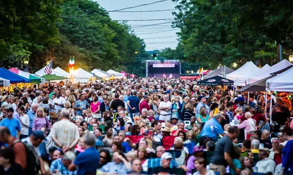 A large crowd of people are gathered at a festival.