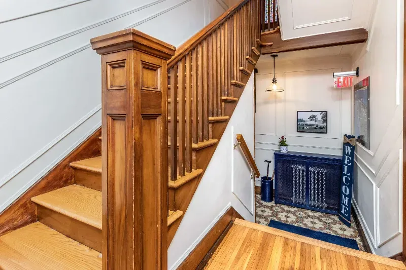 A wooden staircase leading up to the second floor of a building.