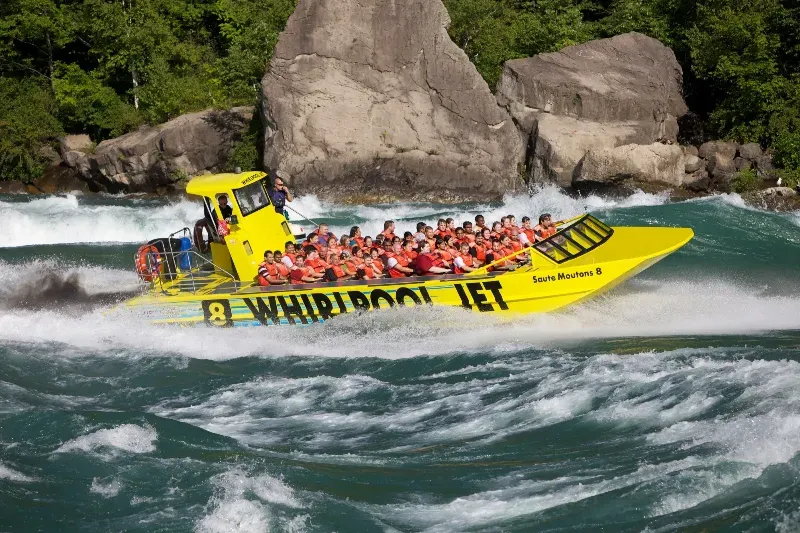 A group of people are riding a whirlpool jet in the water.