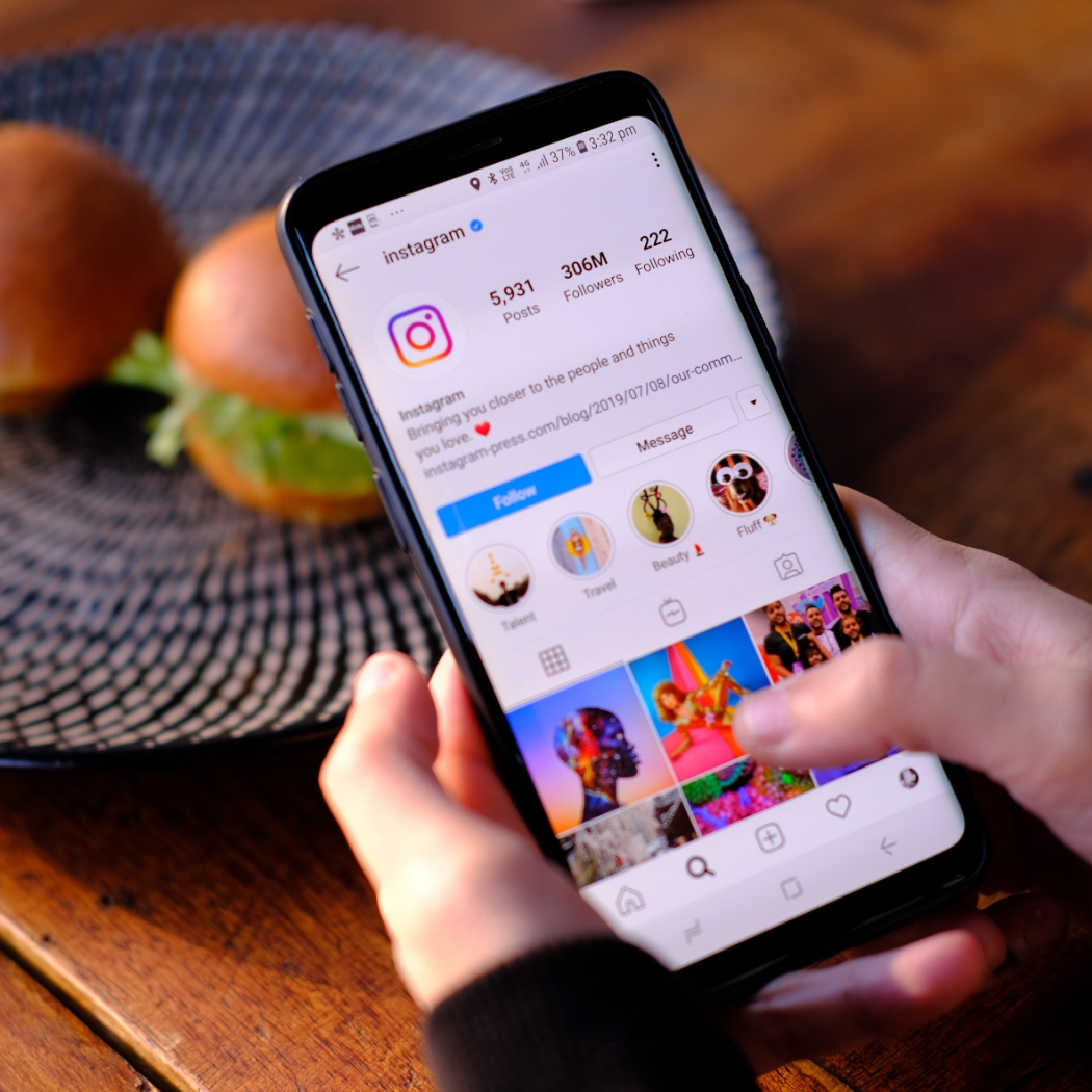 Person viewing Instagram on a smartphone for Instagram ads management.