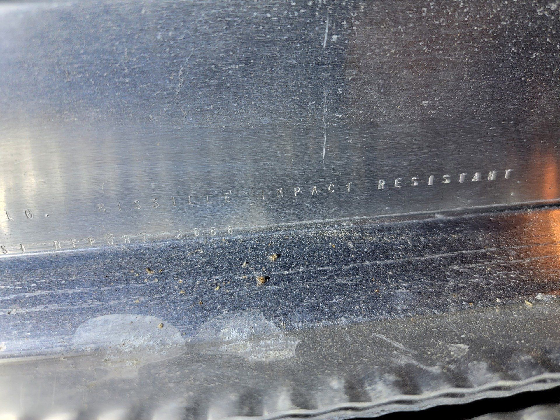 Close-up view of a corrugated metal sheet with the text 
