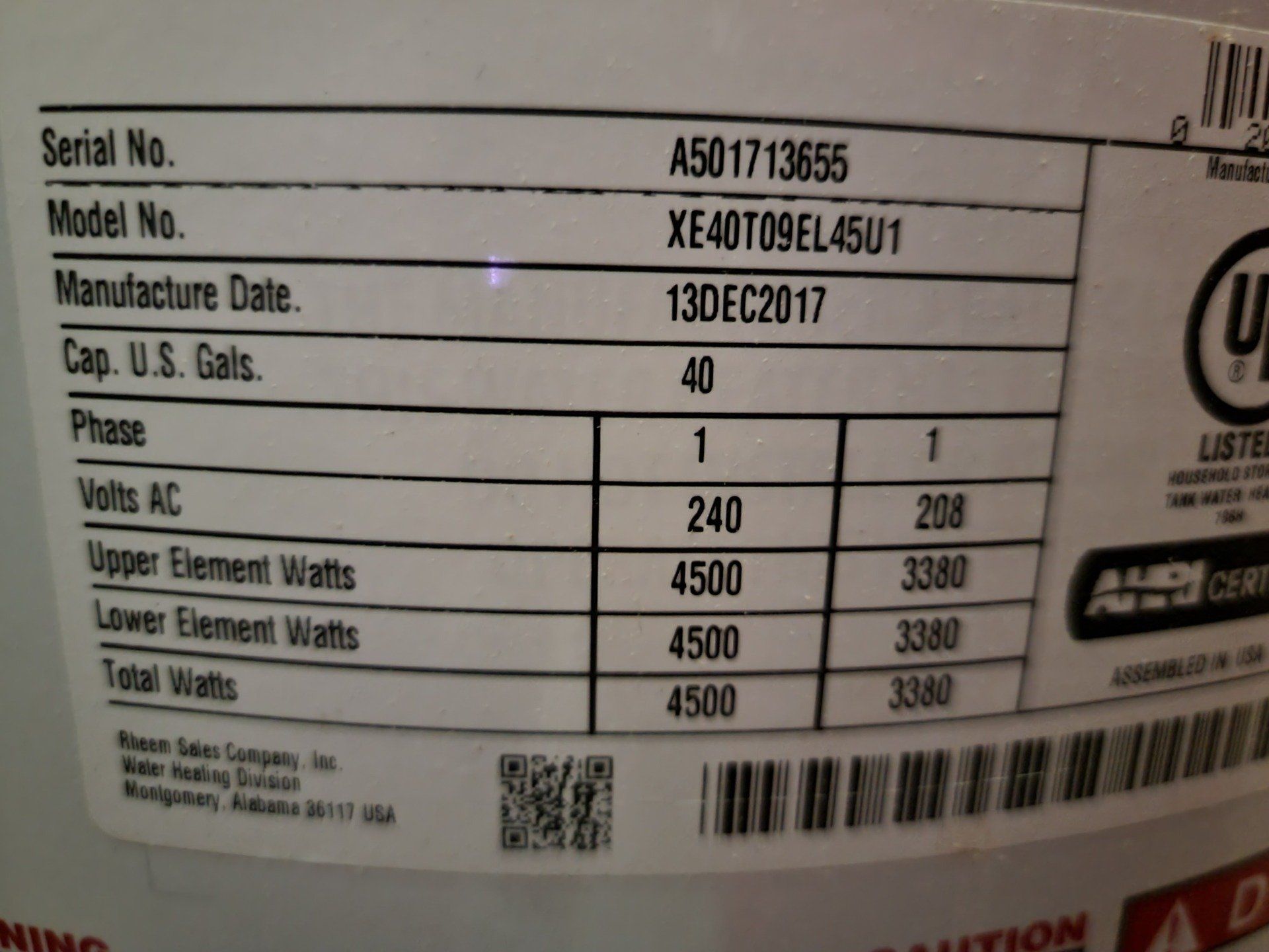 Water heater label showing model, serial number, manufacture date, capacity, electrical specifications.