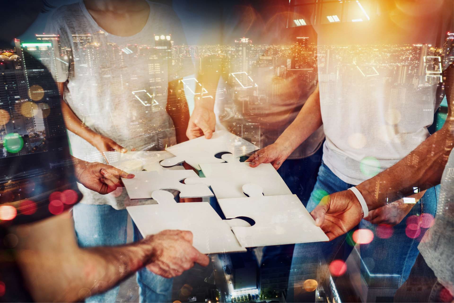 Team of people holding puzzle pieces together