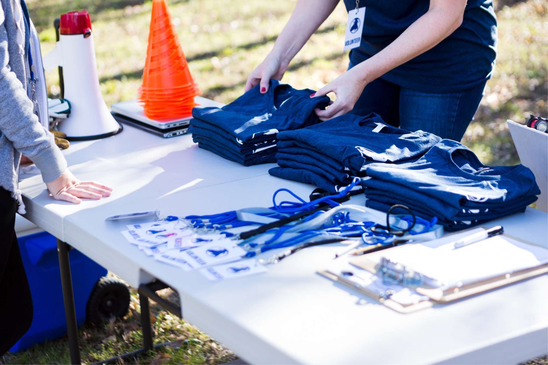 Check-in station at a race with t-shirts on table