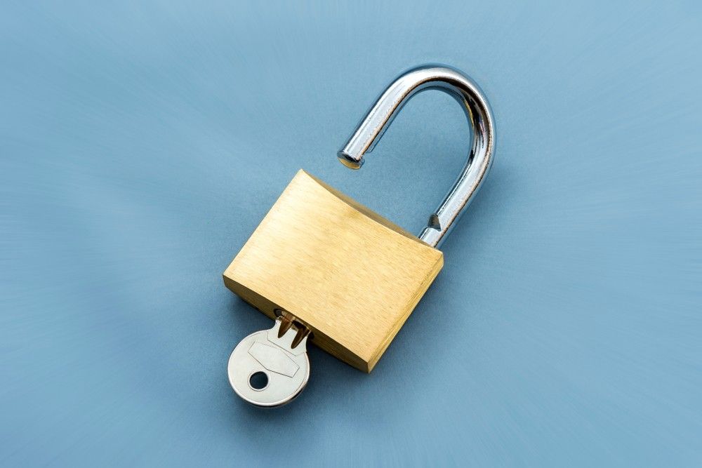 An Open Padlock With a Key — Suresafe Locksmiths in Glenvale, QLD