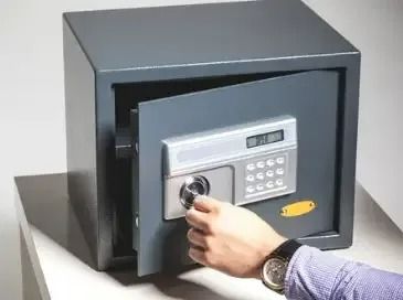 A Person is Opening a Safe With a Key — Suresafe Locksmiths in Glenvale, QLD