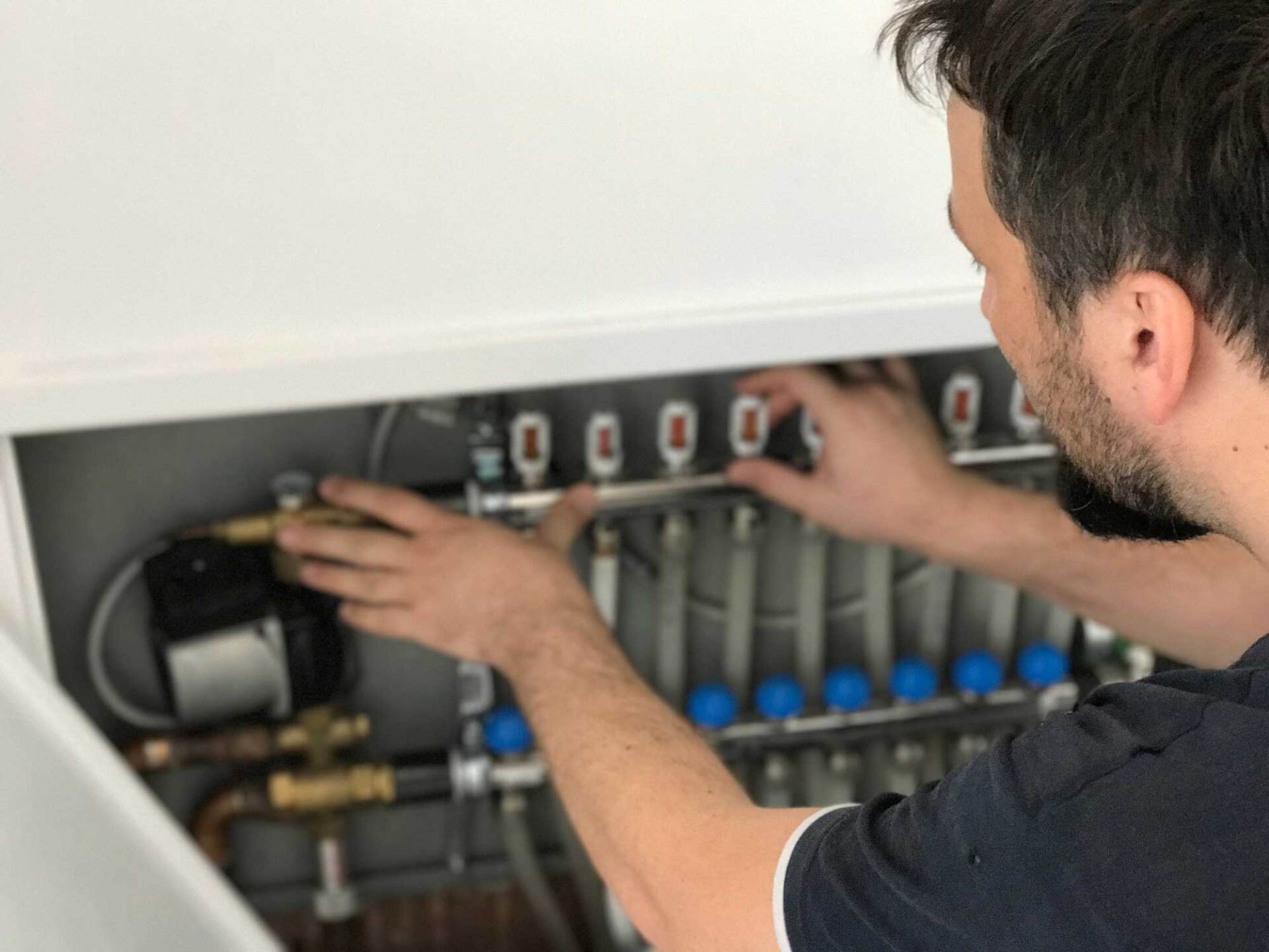 Man Checking and Adjusting Heating System Pipes — Clarksdale, MS — Temperature Control Inc
