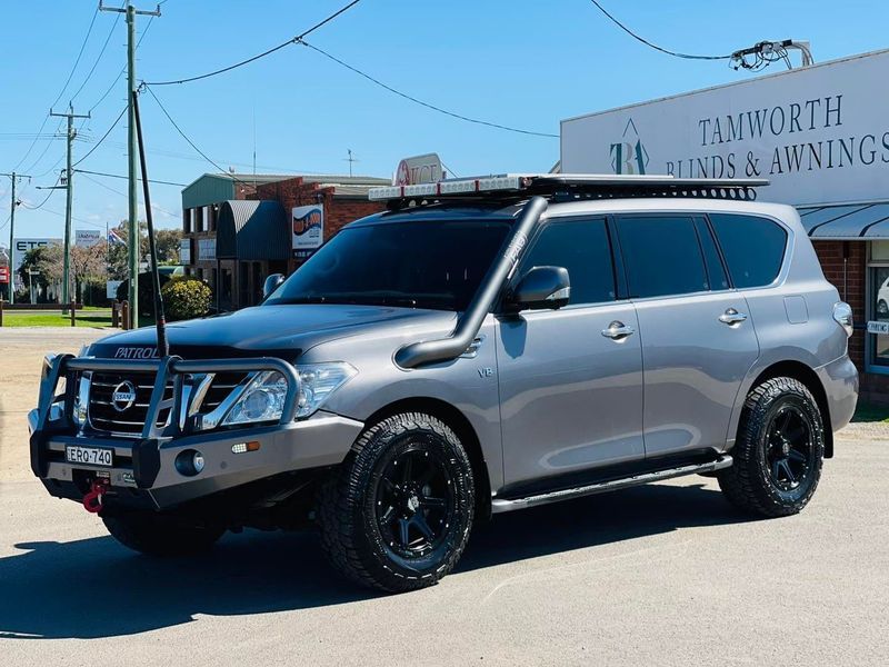 Silver SUV With Black Wheels Parked on a Sunny Street Near a Building — Jake's Car Detailing in Taminda, NSW