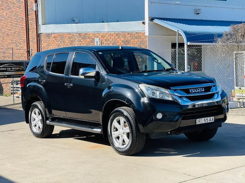 Black SUV Parked Outside a Brick Building in Daylight — Jake's Car Detailing in Taminda, NSW