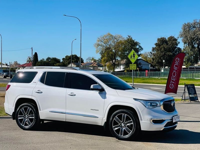 White SUV Parked on a Sunny Street Near a School Crossing Sign and Red Event Banner — Jake's Car Detailing in Taminda, NSW