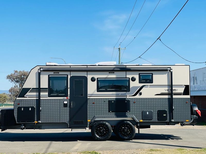 Black and Grey Travel Trailer Parked Outdoors Under a Blue Sky — Jake's Car Detailing in Taminda, NSW