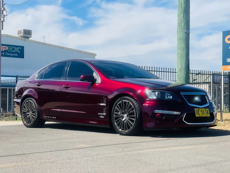 Maroon Sedan Parked by a Fenced Lot Under a Blue Sky — Jake's Car Detailing in Taminda, NSW