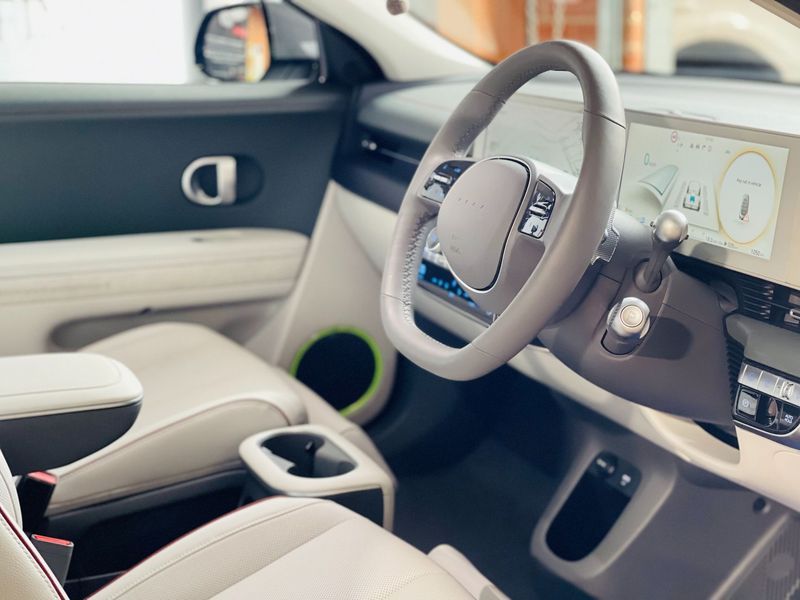 Modern Car Interior With Beige Seats, Steering Wheel, Digital Dashboard — Jake's Car Detailing in Taminda, NSW