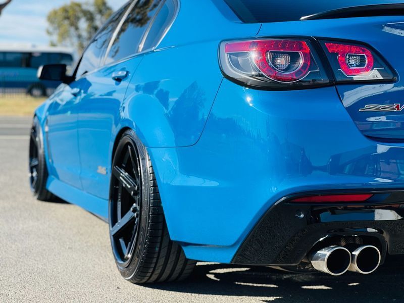 Blue Sports Car Viewed From the Rear on a Sunny Road — Jake's Car Detailing in Taminda, NSW
