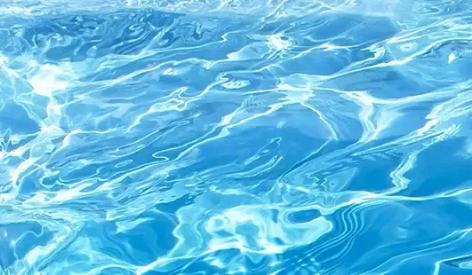 Light blue water with sunlit ripples and reflections
