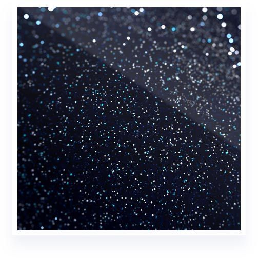 Abstract dark background with shimmering blue and white specks, like stars or glitter.