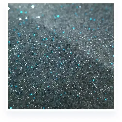 Close-up of gray glitter with scattered turquoise sparkles