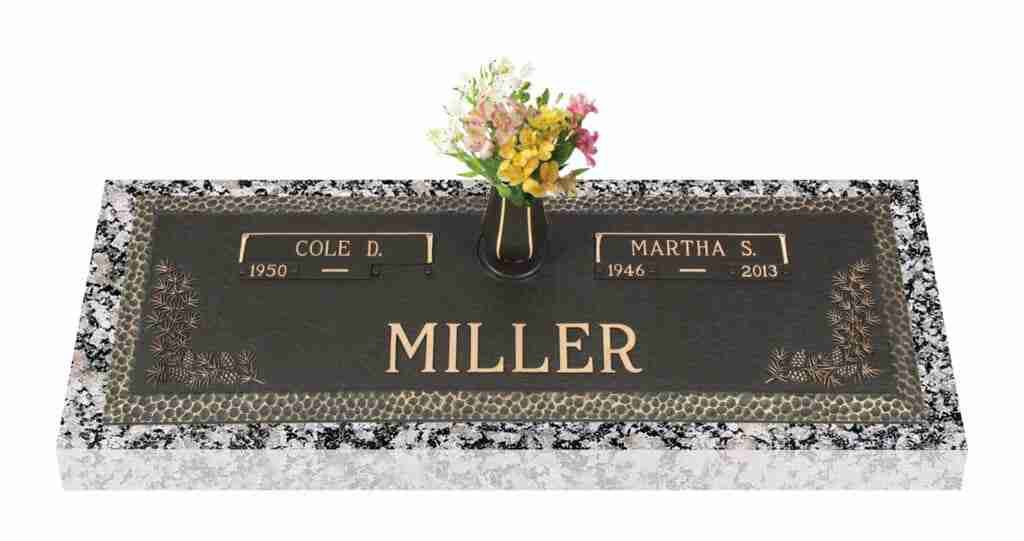 Black granite memorial grave marker with flowers and the name Miller engraved in gold.
