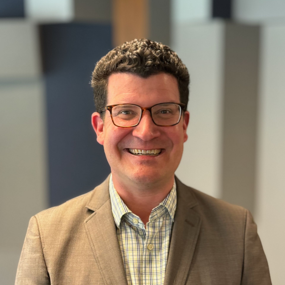 Kemp Mullaney, SaaS Partnerships expert, in business casual clothes, at an industry event at LinkedIn's San Fransisco office.