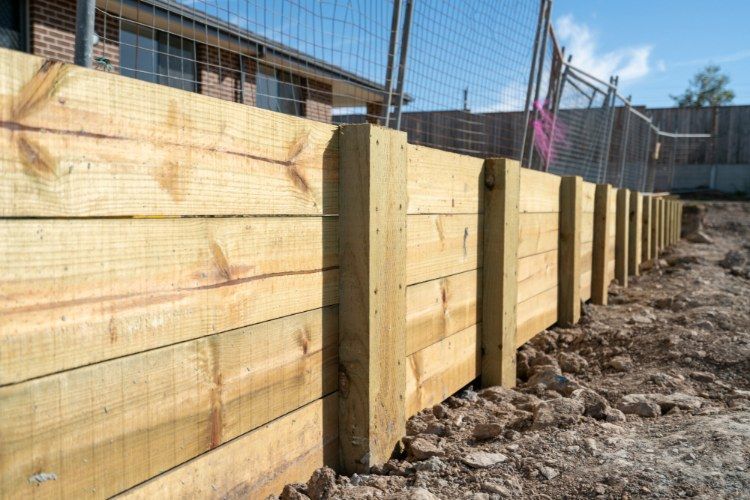 Wooden Fence is Being Built on a Dirt Field — Lange's Fencing & Landscaping Centre in Hervey Bay, QLD