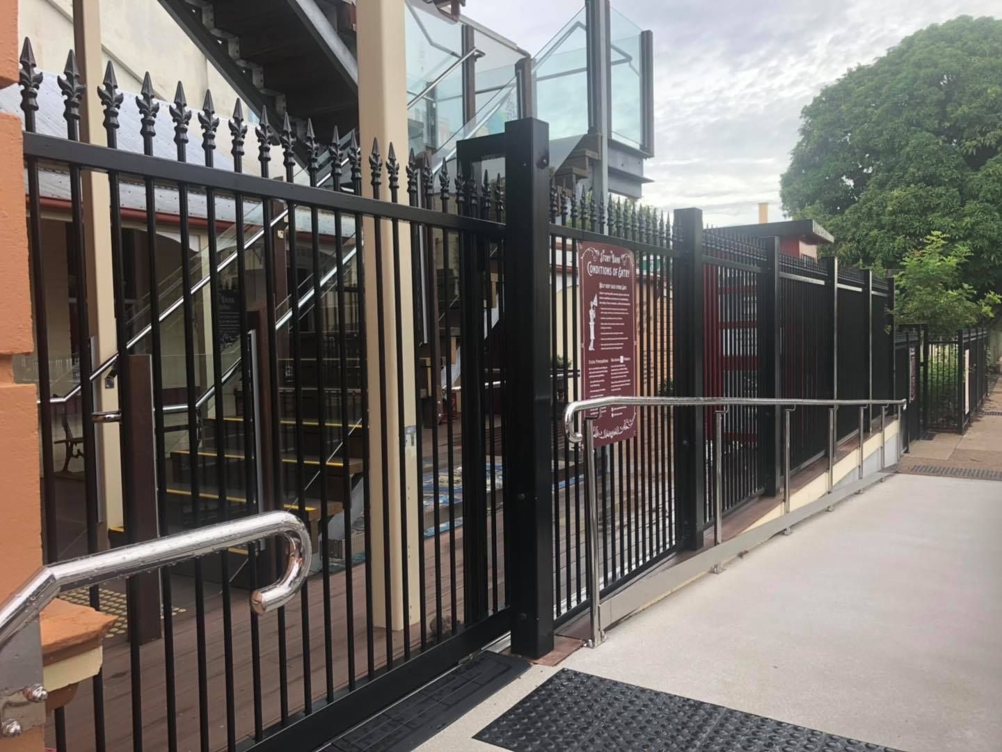 Black Wrought Iron Fence With a Staircase in the Background — Lange's Fencing & Landscaping Centre in Island Plantation, QLD