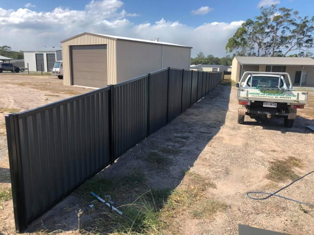 Truck is Parked Next to a Fence in a Dirt Field — Lange's Fencing & Landscaping Centre in Island Plantation, QLD
