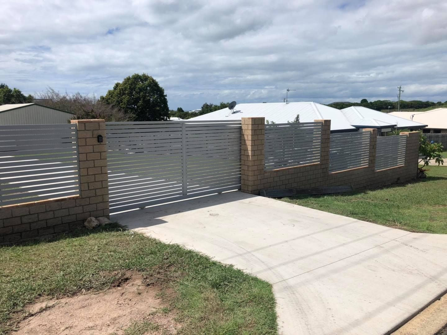 Driveway Leading to a House With a Fence and a Gate — Lange's Fencing & Landscaping Centre in Gympie, QLD