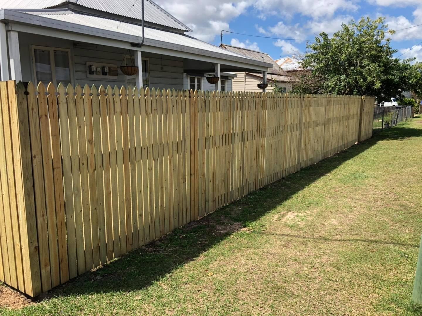 Wooden Picket Fence Along a Grassy Lawn — Lange's Fencing & Landscaping Centre in Island Plantation, QLD