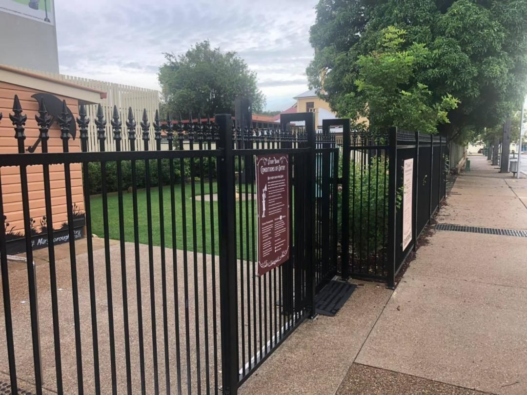 Black Fence With a Sign on It That Says No Dogs Allowed — Lange's Fencing & Landscaping Centre in Hervey Bay, QLD