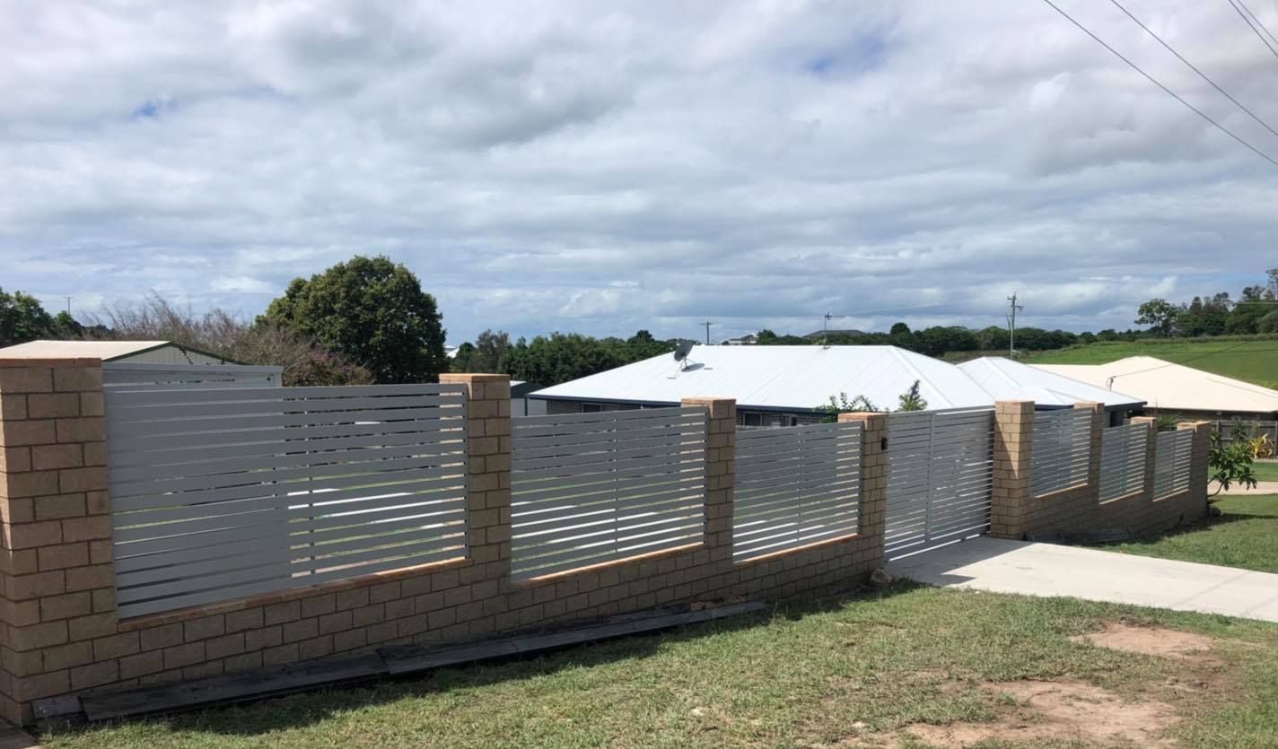 White Fence is Surrounded by Grass and Trees — Lange's Fencing & Landscaping Centre in Island Plantation, QLD