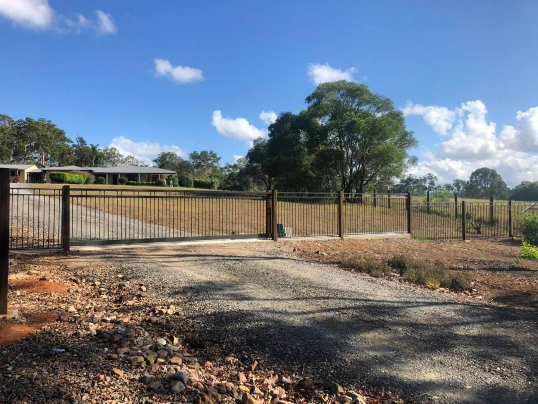 Driveway With a Fence and a House in the Background —Lange’s Fencing & Landscaping Centre in Hervey Bay, QLD