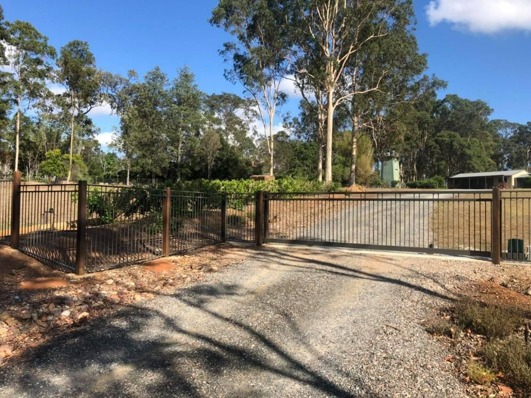 Gravel Driveway Leading to a Fence With Trees in the Background — Lange's Fencing & Landscaping Centre in Island Plantation, QLD