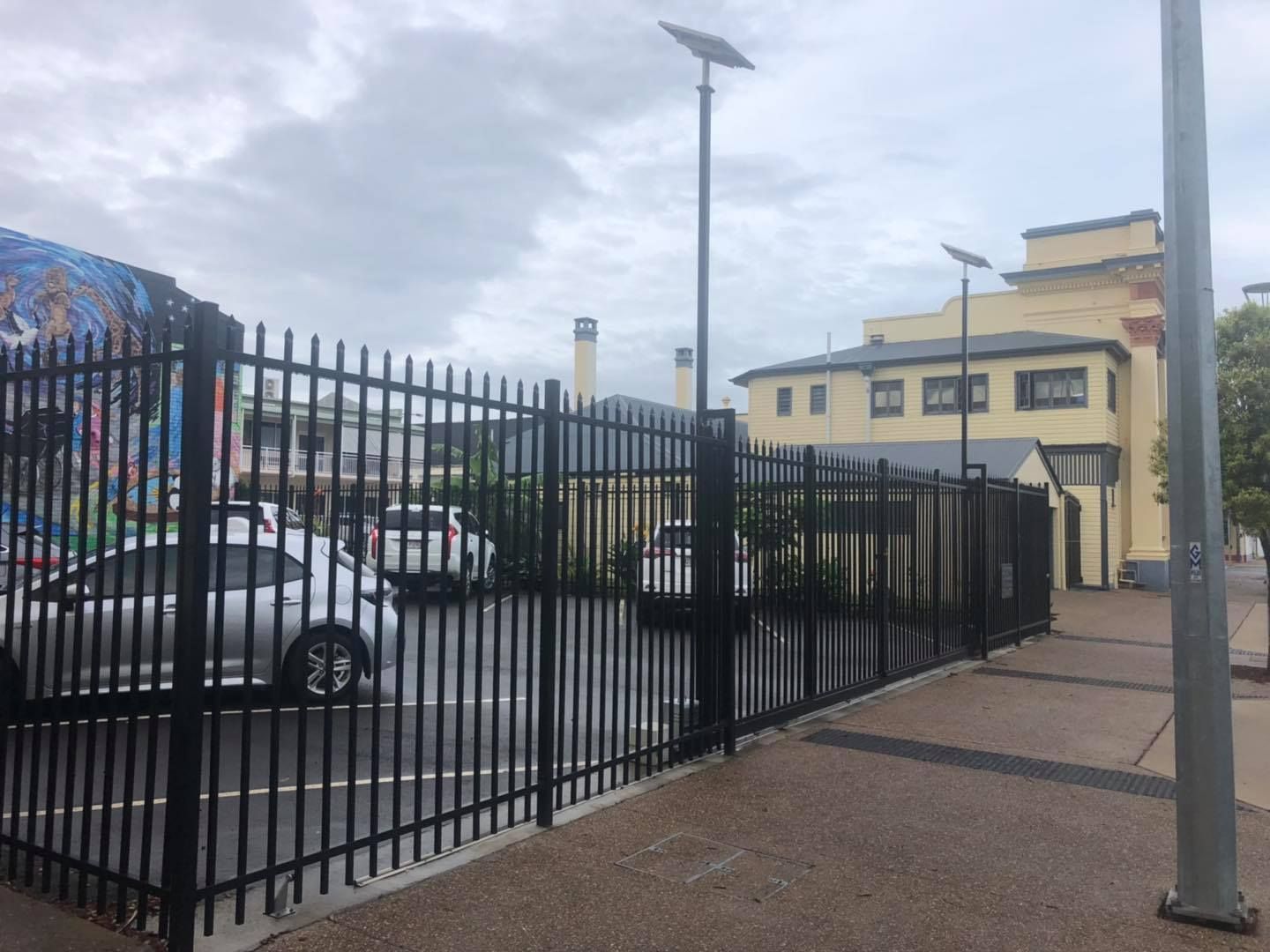 Car is Parked in a Parking Lot Behind a Metal Fence  — Lange's Fencing & Landscaping Centre in Island Plantation, QLD