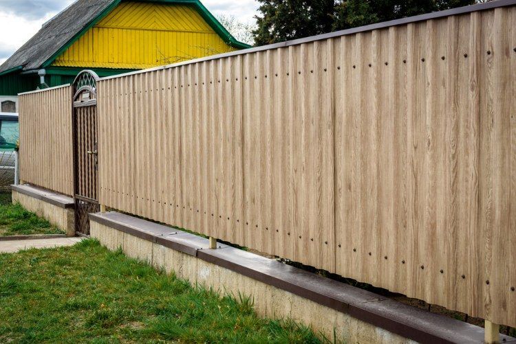 Wooden Fence With a Gate in Front of a House — Lange's Fencing & Landscaping Centre in Gympie, QLD