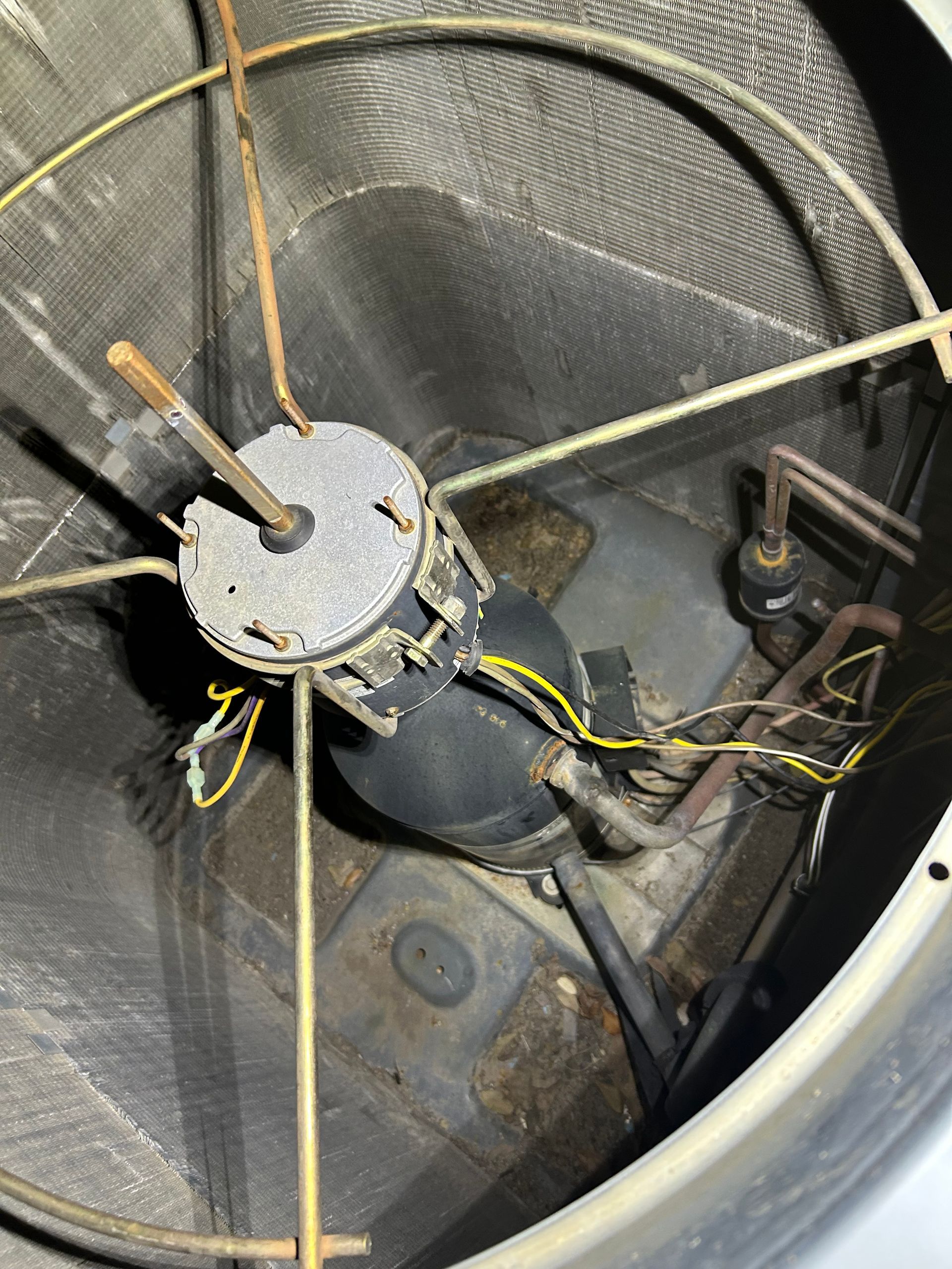 A close up of a fan with wires coming out of it.