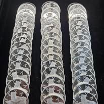Three vertical rows of stacked black-and-white X-ray films on a dark surface