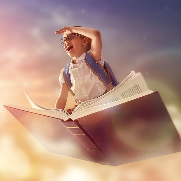 a boy riding a flying book