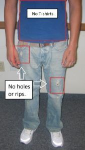 A man wearing a blue t-shirt and jeans has no holes or rips