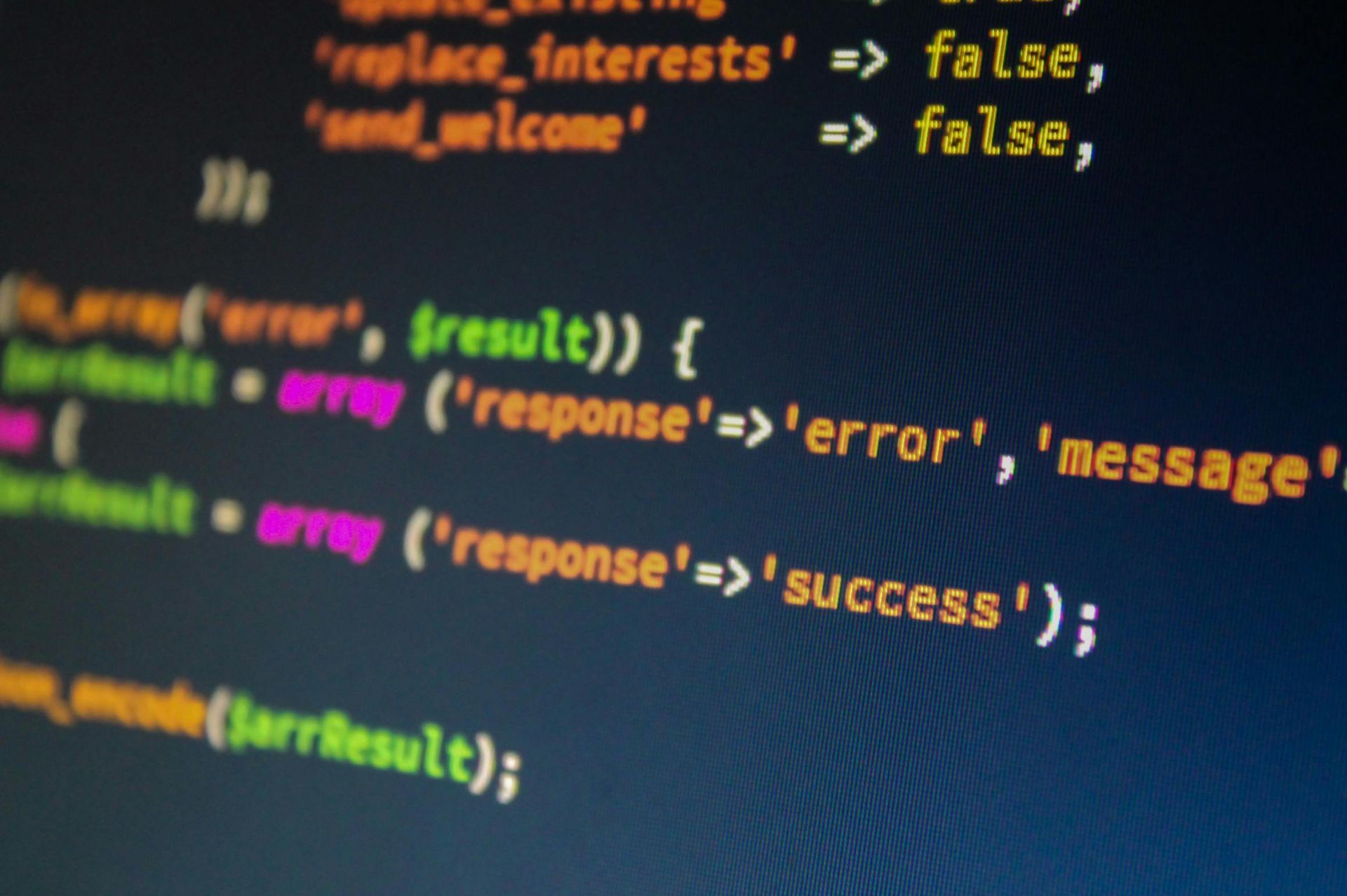 Close-up of code on a dark screen with colorful syntax highlighting