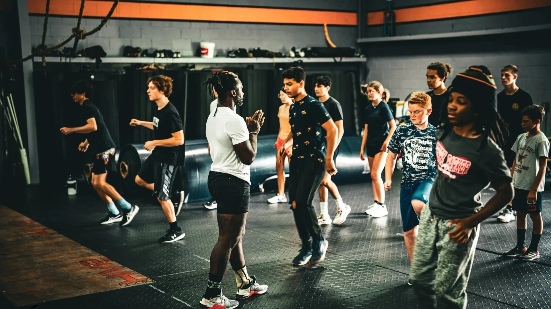 People exercising in a gym, standing in rows during a workout class