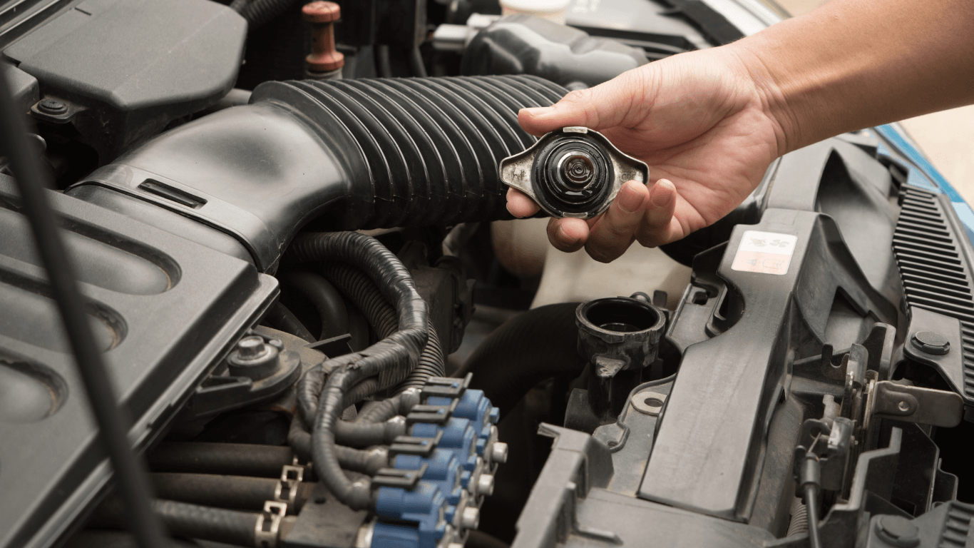 a mechanic doing fluid top-up on a car.