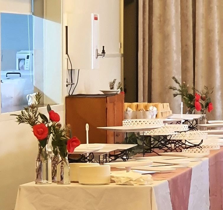 A long table with a vase of flowers on it