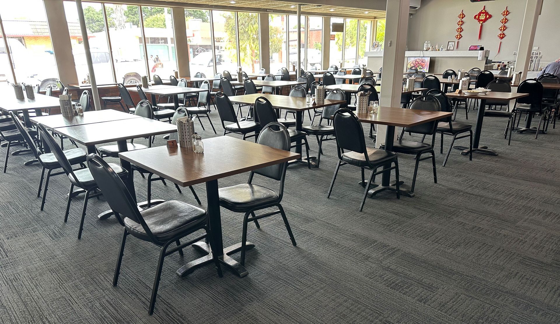 A large room with tables and chairs in a restaurant