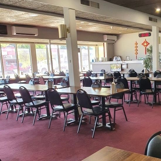 A restaurant with tables and chairs and a red carpet