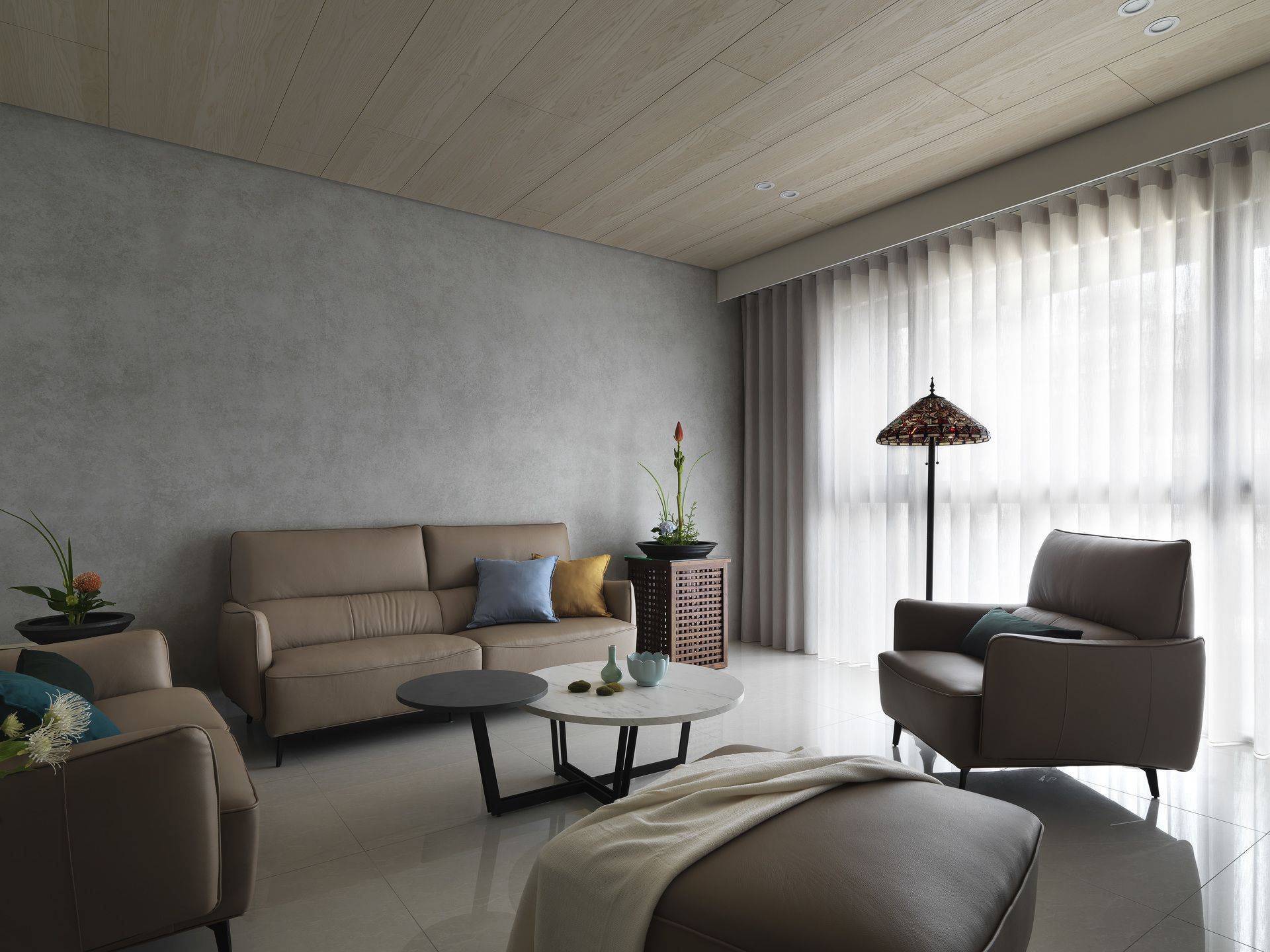 A living room with a couch , chair , coffee table and ottoman.