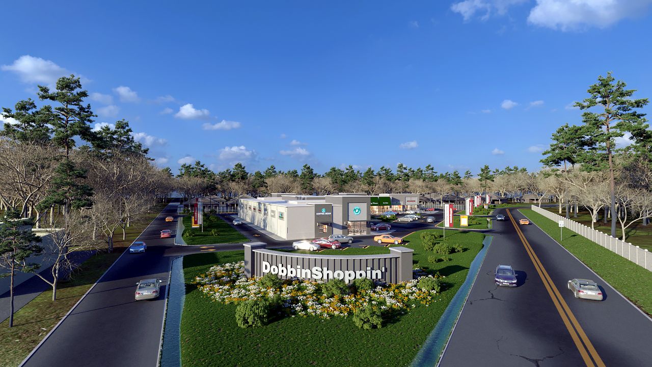 An aerial view of a road with cars driving down it.